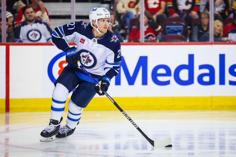 Oct 11, 2023; Calgary, Alberta, CAN; Winnipeg Jets left wing Nikolaj Ehlers (27) controls the puck against the Calgary Flames during the second period at Scotiabank Saddledome. Mandatory Credit: Sergei Belski-USA TODAY Sports