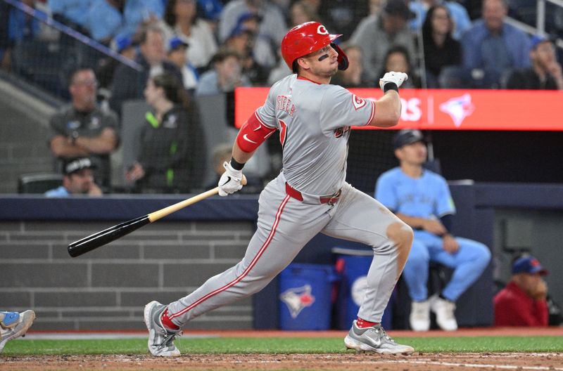 Aug 19, 2024; Toronto, Ontario, CAN; Cincinnati Reds left fielder Spencer Steer (7) hits an RBI double against the Toronto Blue Jays in the sixth inning at Rogers Centre. Mandatory Credit: Dan Hamilton-USA TODAY Sports