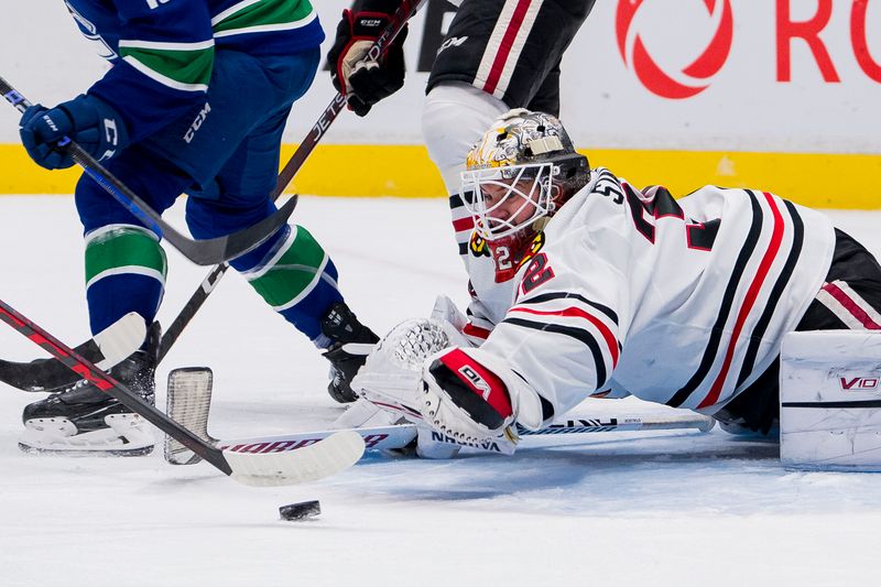 Apr 6, 2023; Vancouver, British Columbia, CAN; Chicago Blackhawks goalie Alex Stalock (32) dives for the loose puck against the Vancouver Canucks in the first period at Rogers Arena. Mandatory Credit: Bob Frid-USA TODAY Sports