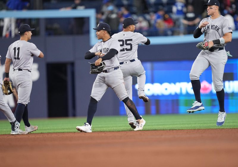 Apr 17, 2024; Toronto, Ontario, CAN; New York Yankees right fielder Juan Soto (22) celebrates the win with shortstop Anthony Volpe (11) against the Toronto Blue Jays at the end of the ninth inning at Rogers Centre. Mandatory Credit: Nick Turchiaro-USA TODAY Sports