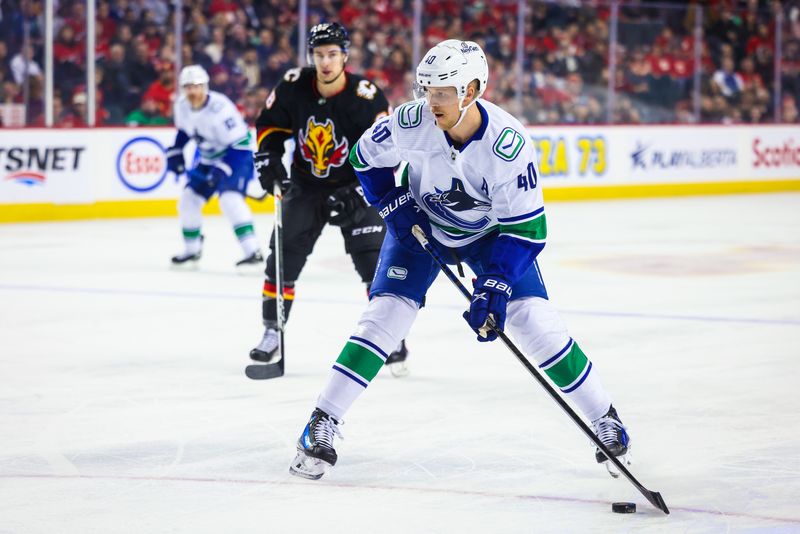 Dec 2, 2023; Calgary, Alberta, CAN; Vancouver Canucks center Elias Pettersson (40) skates with the puck against the Calgary Flames during the first period at Scotiabank Saddledome. Mandatory Credit: Sergei Belski-USA TODAY Sports