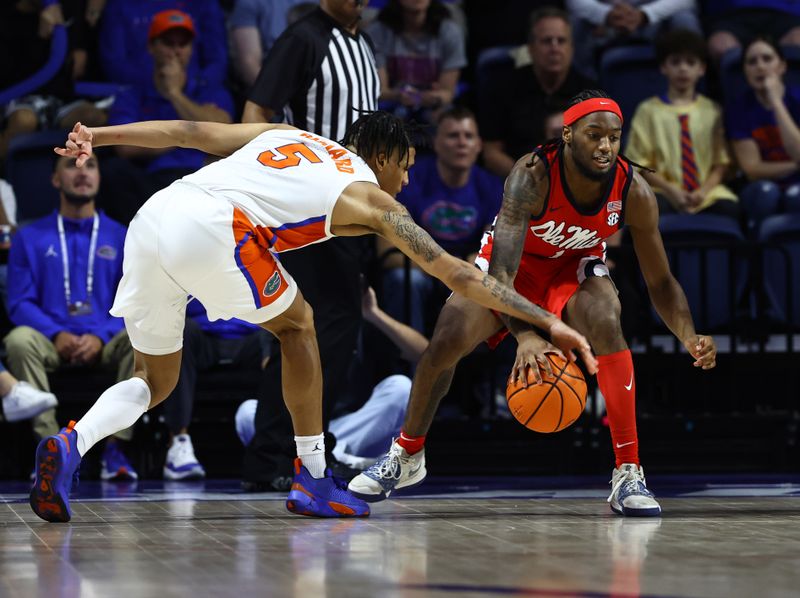 Feb 15, 2023; Gainesville, Florida, USA; Florida Gators guard Will Richard (5) defends Mississippi Rebels guard Amaree Abram (1) during the second half at Exactech Arena at the Stephen C. O'Connell Center. Mandatory Credit: Kim Klement-USA TODAY Sports