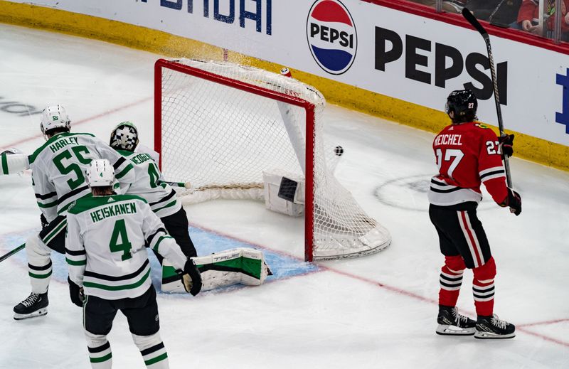 Apr 6, 2024; Chicago, Illinois, USA; Chicago Blackhawks left winger Lukas Reichel (27) watches after assisting a goal by center Andreas Athanasiou (89) against the Dallas Wings during the second period at United Center. Mandatory Credit: Seeger Gray-USA TODAY Sports