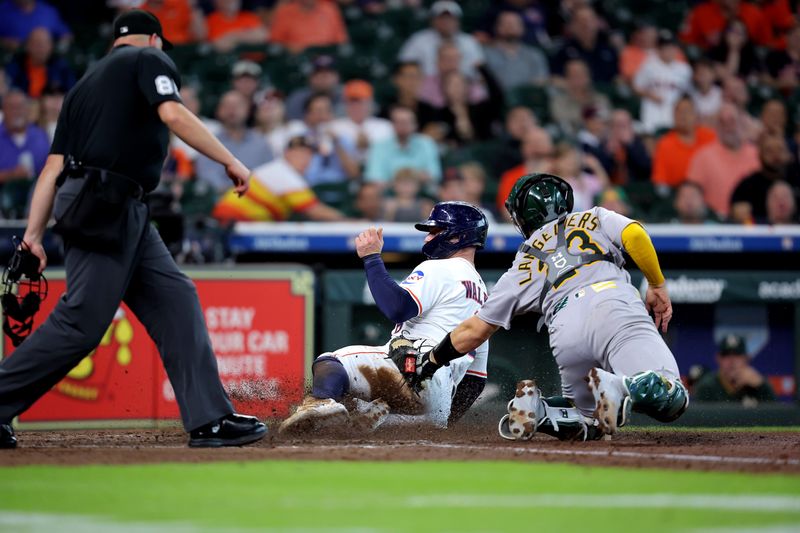 May 28, 2025; Houston, Texas, USA; Houston Astros first baseman Christian Walker (8) slides into home plate to score a run while beating the tag from Athletics catcher Shea Langeliers (23) during the fourth inning at Daikin Park. Mandatory Credit: Erik Williams-Imagn Images