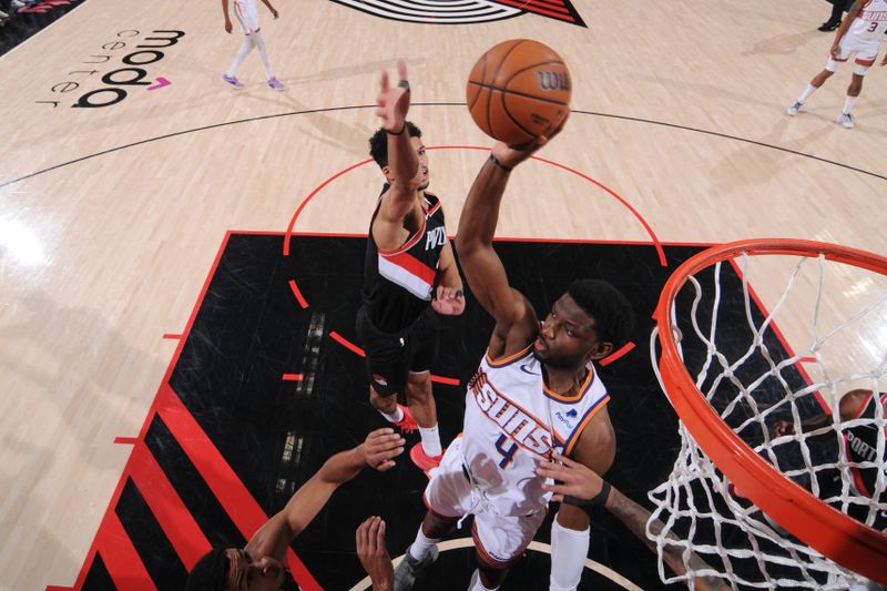 PORTLAND, OR - JANUARY 14: Chimezie Metu #4 of the Phoenix Suns passes the ball during the game against the Portland Trail Blazers on January 14, 2024 at the Moda Center Arena in Portland, Oregon. NOTE TO USER: User expressly acknowledges and agrees that, by downloading and or using this photograph, user is consenting to the terms and conditions of the Getty Images License Agreement. Mandatory Copyright Notice: Copyright 2024 NBAE (Photo by Cameron Browne/NBAE via Getty Images)