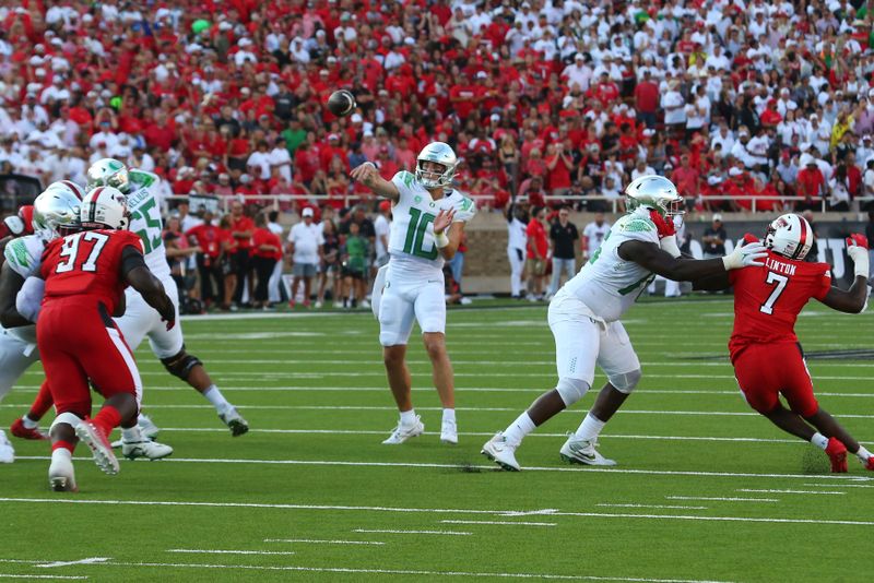 Sep 9, 2023; Lubbock, Texas, USA; Oregon Ducks quarterback Bo Nix (10) passes against Texas Tech Red Raiders defensive lineman Tony Bradford Jr. (97) and defensive linebacker Steve Linton (7) in the first half at Jones AT&T Stadium and Cody Campbell Field. Mandatory Credit: Michael C. Johnson-USA TODAY Sports