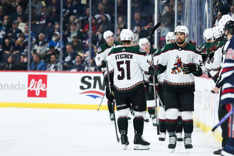 Nov 18, 2023; Winnipeg, Manitoba, CAN; Arizona Coyotes defenseman Matt Dumba (24) is congratulated by Arizona Coyotes defenseman Troy Stecher (51) on his goal against the Winnipeg Jets during the second period at Canada Life Centre. Mandatory Credit: Terrence Lee-USA TODAY Sports