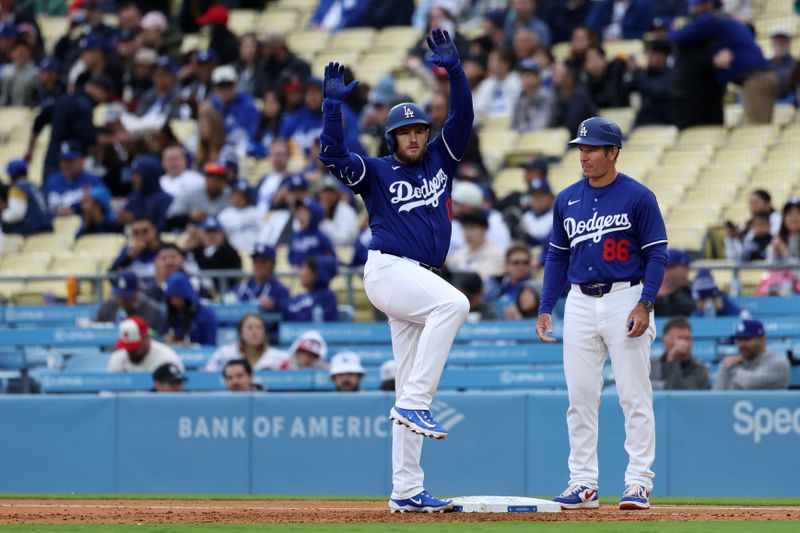Mar 24, 2024; Los Angeles, California, USA;  Los Angeles Dodgers third baseman Max Muncy (13) reacts after hitting a single during the second inning against the Los Angeles Angels at Dodger Stadium. Mandatory Credit: Kiyoshi Mio-USA TODAY Sports