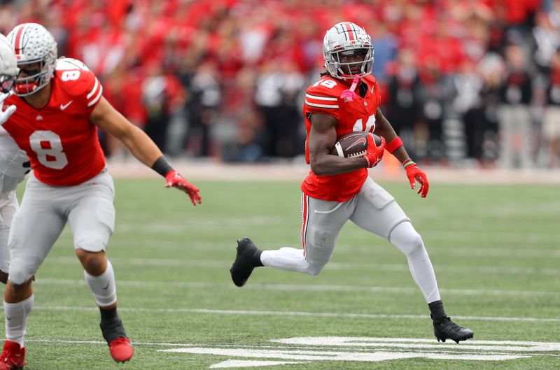 Oct 21, 2023; Columbus, Ohio, USA;  Ohio State Buckeyes wide receiver Marvin Harrison Jr. (18) runs the ball against the Penn State Nittany Lions during the second quarter at Ohio Stadium. Mandatory Credit: Joseph Maiorana-USA TODAY Sports