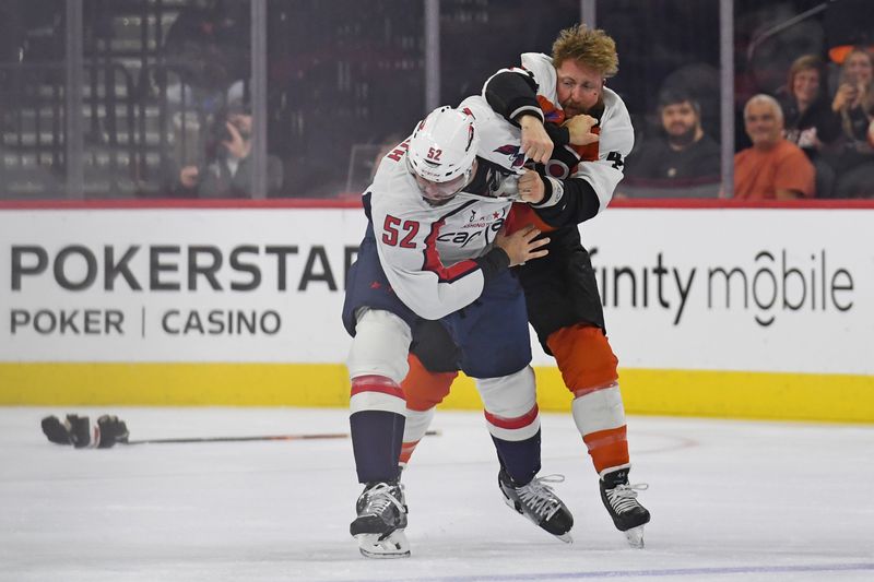 Oct 22, 2024; Philadelphia, Pennsylvania, USA; Philadelphia Flyers left wing Nicolas Deslauriers (44) and Washington Capitals defenseman Dylan McIlrath (52) fight during the first period at Wells Fargo Center. Mandatory Credit: Eric Hartline-Imagn Images