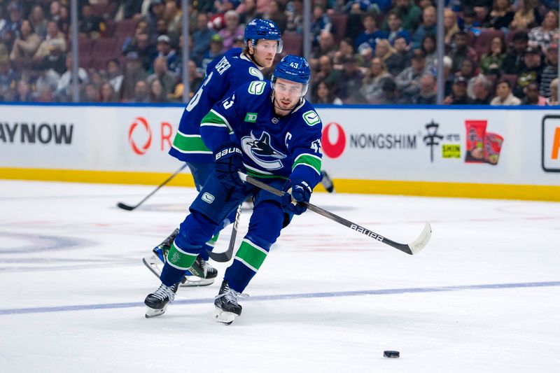 Oct 11, 2024; Vancouver, British Columbia, CAN; Vancouver Canucks forward Brock Boeser (6) watches as defenseman Quinn Hughes (43) passes the puck against the Philadelphia Flyers during the third period at Rogers Arena. Mandatory Credit: Bob Frid-Imagn Images