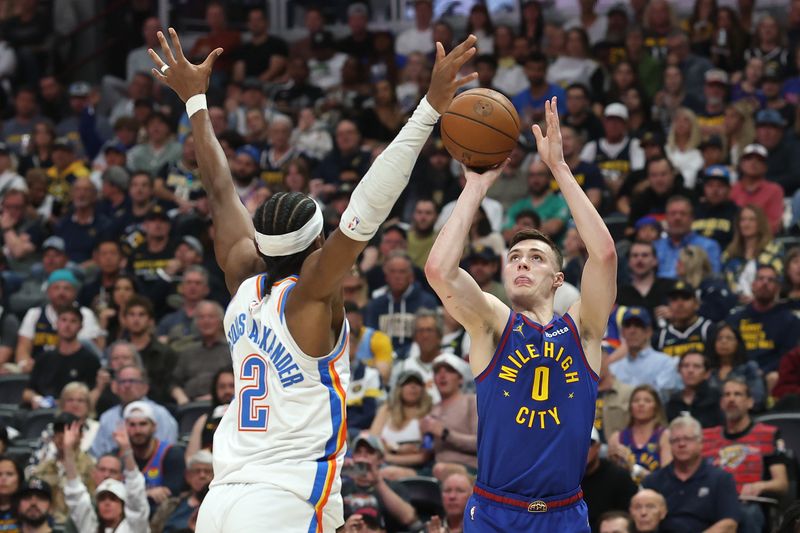DENVER, COLORADO - MAY 09: Christian Braun #0 of the Denver Nuggets shoots the ball against Shai Gilgeous-Alexander #2 of the Oklahoma City Thunder during the second quarter in Game Three of the Western Conference Second Round NBA Playoffs at Ball Arena on May 09, 2025 in Denver, Colorado. NOTE TO USER: User expressly acknowledges and agrees that, by downloading and or using this photograph, User is consenting to the terms and conditions of the Getty Images License Agreement. (Photo by Matthew Stockman/Getty Images)