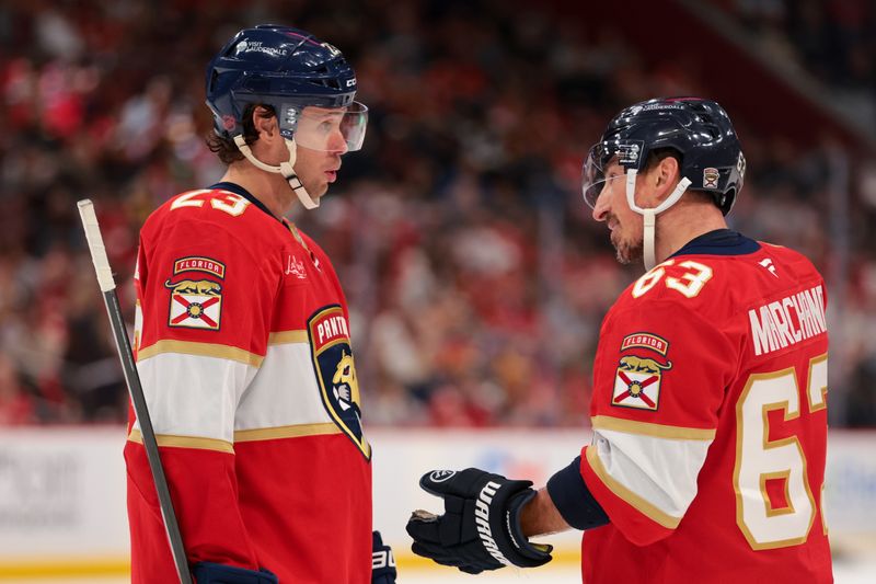 Dec 4, 2025; Sunrise, Florida, USA; Florida Panthers center Carter Verhaeghe (23) and left wing Brad Marchand (63) speak against the Nashville Predators during the second period at Amerant Bank Arena. Mandatory Credit: Sam Navarro-Imagn Images