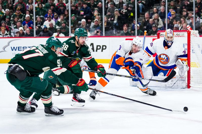 Jan 15, 2024; Saint Paul, Minnesota, USA; New York Islanders defenseman Adam Pelech (3) pokes the puck away from Minnesota Wild right wing Mats Zuccarello (36) and left wing Kirill Kaprizov (97) during the second period at Xcel Energy Center. Mandatory Credit: Brace Hemmelgarn-USA TODAY Sports