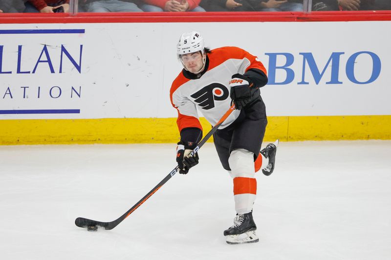 Feb 21, 2024; Chicago, Illinois, USA; Philadelphia Flyers defenseman Jamie Drysdale (9) passes the puck against the Chicago Blackhawks during the second period at United Center. Mandatory Credit: Kamil Krzaczynski-USA TODAY Sports