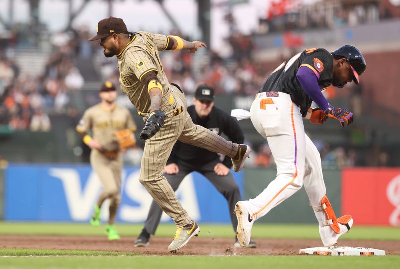 Jun 3, 2025; San Francisco, California, USA; San Francisco Giants right fielder Jerar Encarnacion (59) safe at first base behind San Diego Padres first baseman Luis Arraez (4) during the sixth inning at Oracle Park. Mandatory Credit: Kelley L Cox-Imagn Images