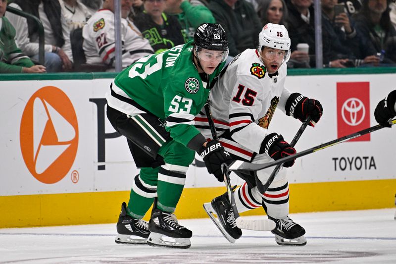 Oct 26, 2024; Dallas, Texas, USA; Dallas Stars center Wyatt Johnston (53) and Chicago Blackhawks center Craig Smith (15) look for the puck during the first period at the American Airlines Center. Mandatory Credit: Jerome Miron-Imagn Images