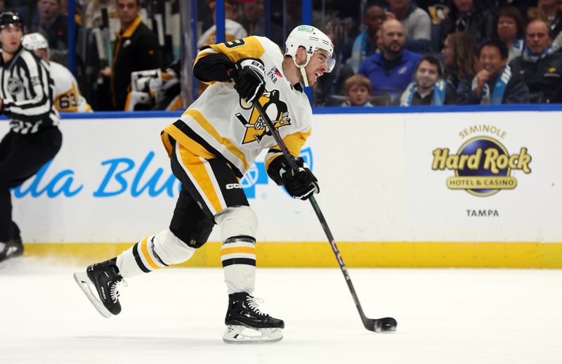 Dec 6, 2023; Tampa, Florida, USA; Pittsburgh Penguins right wing Reilly Smith (19) passes the puck against the Tampa Bay Lightning during the second period at Amalie Arena. Mandatory Credit: Kim Klement Neitzel-USA TODAY Sports
