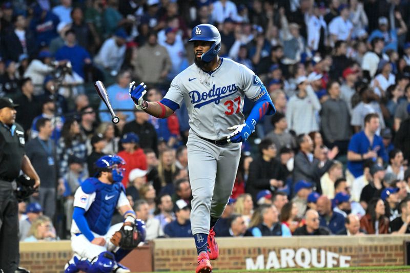 Apr 23, 2025; Chicago, Illinois, USA;  Los Angeles Dodgers outfielder Teoscar Hernández (37) flips his bat after hitting a two-run home run during the fifth inning against the Chicago Cubs at Wrigley Field. Mandatory Credit: Matt Marton-Imagn Images