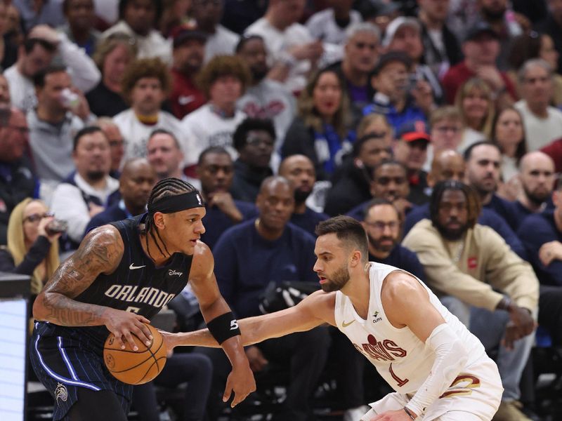 CLEVELAND, OH - APRIL 22: Paolo Banchero #5 of the Orlando Magic dribbles the ball during the game against the Cleveland Cavaliers during Round 1 Game 2 of the 2024 NBA Playoffs on April 22, 2024 at Rocket Mortgage FieldHouse in Cleveland, Ohio. NOTE TO USER: User expressly acknowledges and agrees that, by downloading and/or using this Photograph, user is consenting to the terms and conditions of the Getty Images License Agreement. Mandatory Copyright Notice: Copyright 2024 NBAE (Photo by Lauren Leigh Bacho/NBAE via Getty Images)