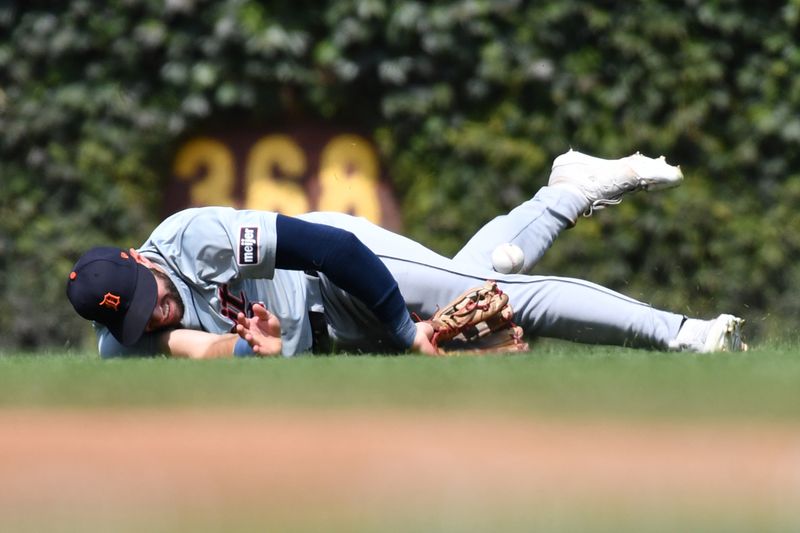 Aug 22, 2024; Chicago, Illinois, USA; Detroit Tigers center fielder Matt Vierling (8) attempts to catch a single hit by Chicago Cubs shortstop Dansby Swanson (not pictured) during the second inning at Wrigley Field. Mandatory Credit: Patrick Gorski-USA TODAY Sports