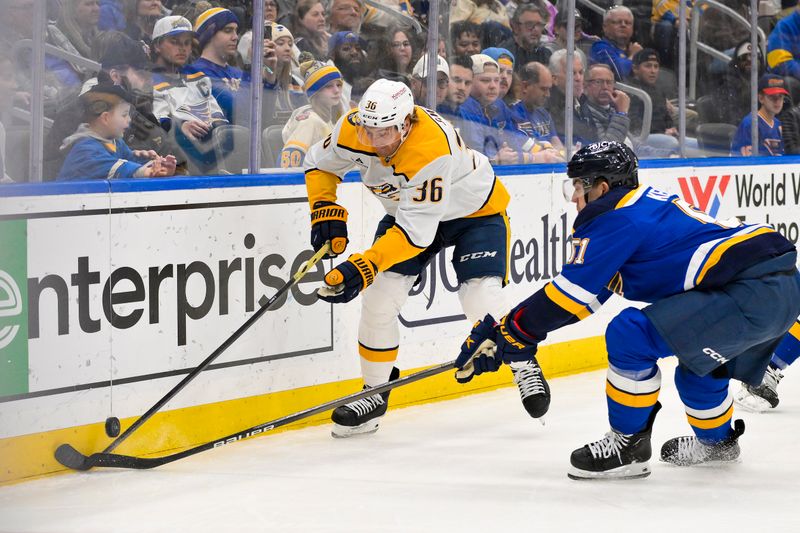 Mar 23, 2025; St. Louis, Missouri, USA;  Nashville Predators left wing Cole Smith (36) and St. Louis Blues defenseman Matthew Kessel (51) battle for the puck during the first period at Enterprise Center. Mandatory Credit: Jeff Curry-Imagn Images