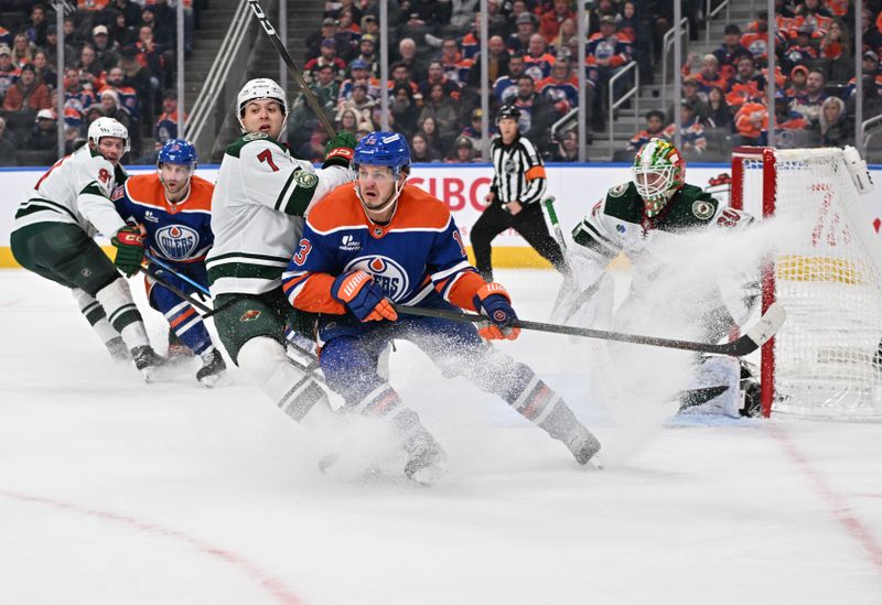 Dec 2, 2025; Edmonton, Alberta, CAN;  Minnesota Wild defenseman Brock Faber (7) and Edmonton Oilers center Mattias Janmark (13) battle in front of Minnesota Wild goalie Jesper Wallstedt (30) during the third period at Rogers Place. Mandatory Credit: Walter Tychnowicz-Imagn Images