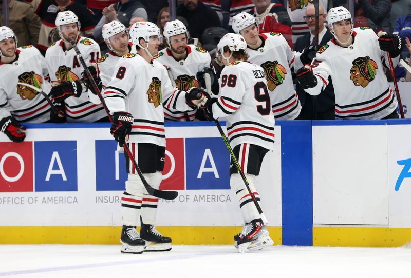 Jan 28, 2025; Tampa, Florida, USA; Chicago Blackhawks center Connor Bedard (98) is congratulated after he scored a goal against the Tampa Bay Lightning during the second period at Amalie Arena. Mandatory Credit: Kim Klement Neitzel-Imagn Images