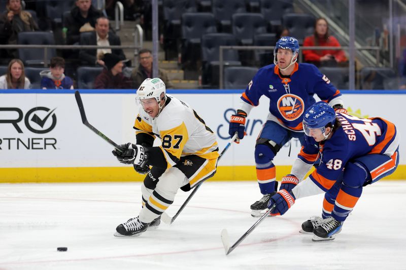 Feb 3, 2026; Elmont, New York, USA; Pittsburgh Penguins center Sidney Crosby (87) skates with the puck past New York Islanders defenseman Matthew Schaefer (48) and center Casey Cizikas (53) during the first period at UBS Arena. Mandatory Credit: Brad Penner-Imagn Images