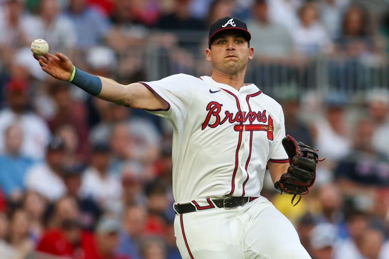 May 8, 2024; Atlanta, Georgia, USA; Atlanta Braves third baseman Austin Riley (27) throws a runner out at first against the Boston Red Sox in the second inning at Truist Park. Mandatory Credit: Brett Davis-USA TODAY Sports
