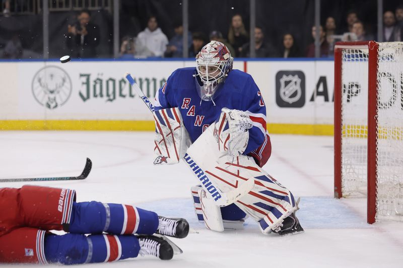 May 13, 2024; New York, New York, USA; New York Rangers goaltender Igor Shesterkin (31) plays the puck against the Carolina Hurricanes during the first period of game five of the second round of the 2024 Stanley Cup Playoffs at Madison Square Garden. Mandatory Credit: Brad Penner-USA TODAY Sports