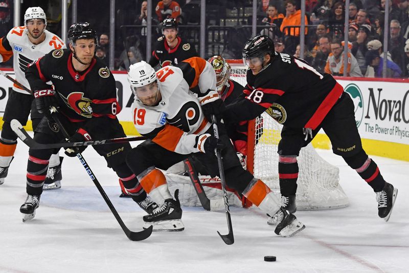 Mar 2, 2024; Philadelphia, Pennsylvania, USA; Philadelphia Flyers right wing Garnet Hathaway (19) battles against Ottawa Senators defenseman Jakob Chychrun (6) and  center Tim Stutzle (18) during the third period at Wells Fargo Center. Mandatory Credit: Eric Hartline-USA TODAY Sports