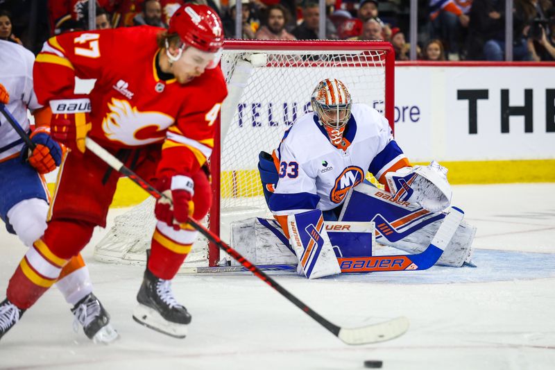 Jan 17, 2026; Calgary, Alberta, CAN; New York Islanders goaltender David Rittich (33) guards his net against Calgary Flames center Connor Zary (47) during the second period at Scotiabank Saddledome. Mandatory Credit: Sergei Belski-Imagn Images
