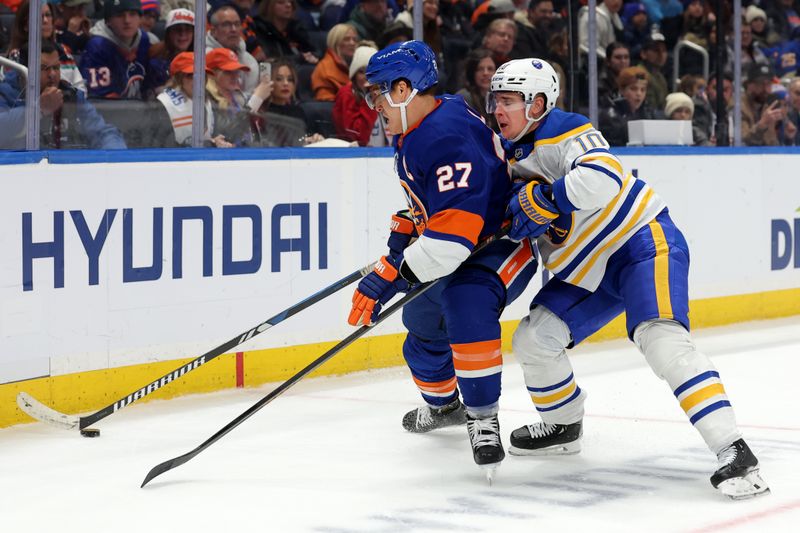 Nov 30, 2024; Elmont, New York, USA; New York Islanders left wing Anders Lee (27) and Buffalo Sabres defenseman Henri Jokiharju (10) fight for the puck during the second period at UBS Arena. Mandatory Credit: Brad Penner-Imagn Images