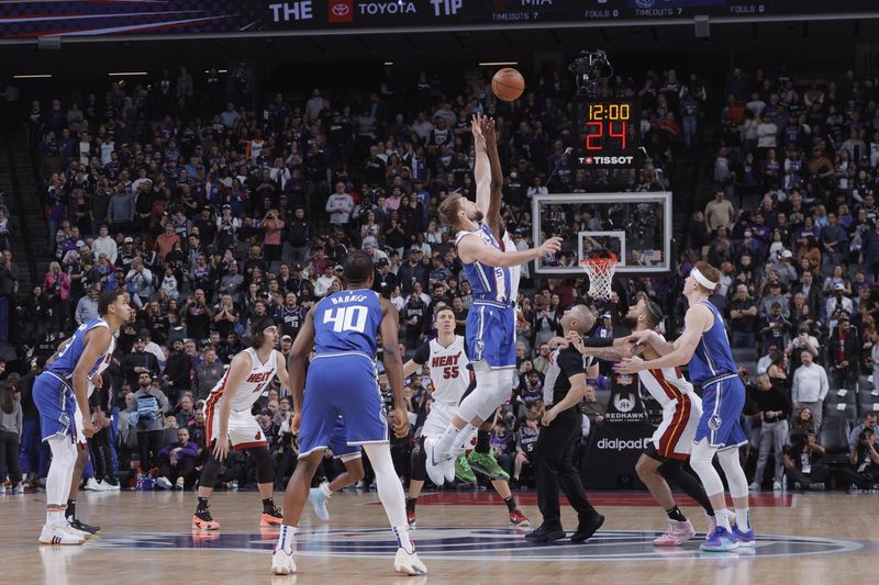 SACRAMENTO, CA - FEBRUARY 26: Domantas Sabonis #10 of the Sacramento Kings and Bam Adebayo #13 of the Miami Heat go up for a jump ball on February 26, 2024 at Golden 1 Center in Sacramento, California. NOTE TO USER: User expressly acknowledges and agrees that, by downloading and or using this Photograph, user is consenting to the terms and conditions of the Getty Images License Agreement. Mandatory Copyright Notice: Copyright 2024 NBAE (Photo by Rocky Widner/NBAE via Getty Images)