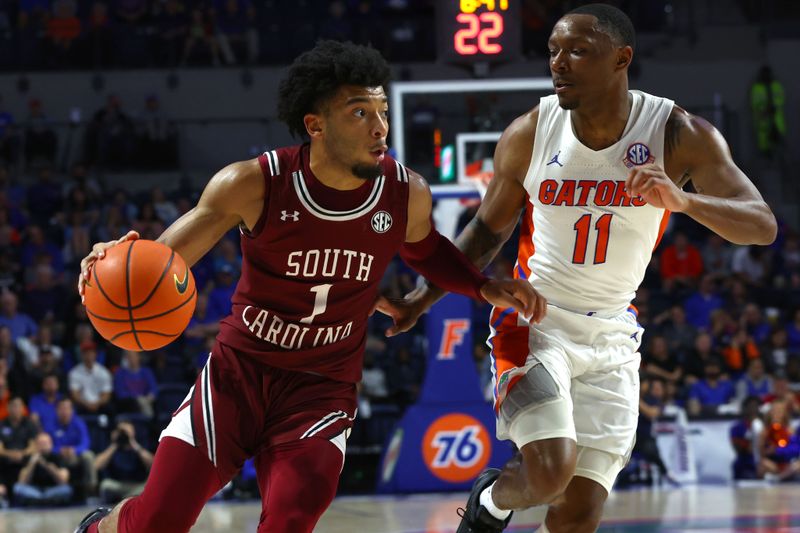 Jan 25, 2023; Gainesville, Florida, USA; South Carolina Gamecocks guard Jacobi Wright (1) drives to the basket as Florida Gators guard Kyle Lofton (11) defends during the first half at Exactech Arena at the Stephen C. O'Connell Center. Mandatory Credit: Kim Klement-USA TODAY Sports