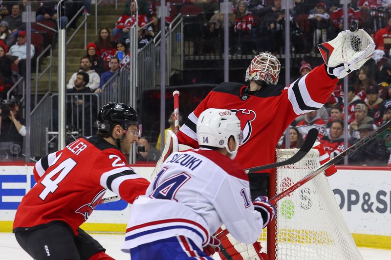 Jan 17, 2024; Newark, New Jersey, USA; New Jersey Devils goaltender Nico Daws (50) catches the puck against the Montreal Canadiens during the third period at Prudential Center. Mandatory Credit: Ed Mulholland-USA TODAY Sports