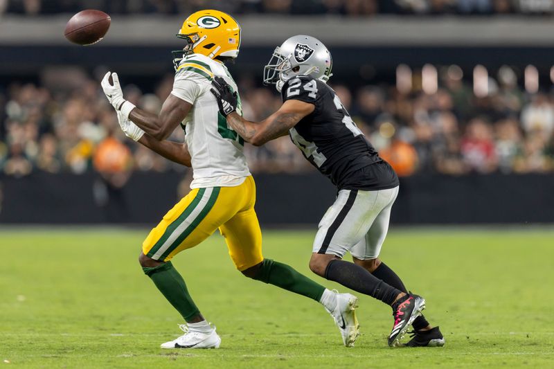 Las Vegas Raiders cornerback Marcus Peters (24) covers Green Bay Packers wide receiver Romeo Doubs in an NFL football game, Monday, Oct. 9, 2023, in Las Vegas, NV. Raiders won 17-13. (AP Photo/Jeff Lewis)