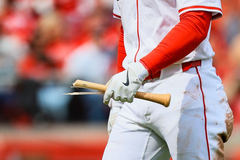 Apr 13, 2025; Cincinnati, Ohio, USA; Cincinnati Reds outfielder Gavin Lux (2) holds his broken bat as he walks off the field in the eighth inning against the Pittsburgh Pirates  at Great American Ball Park. Mandatory Credit: Katie Stratman-Imagn Images