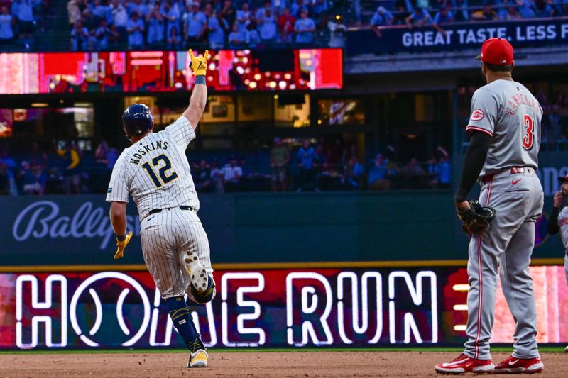 Aug 10, 2024; Milwaukee, Wisconsin, USA; Milwaukee Brewers first baseman Rhys Hoskins (12) reacts after hitting a solo home run in the eighth inning against the Cincinnati Reds at American Family Field. Mandatory Credit: Benny Sieu-USA TODAY Sports