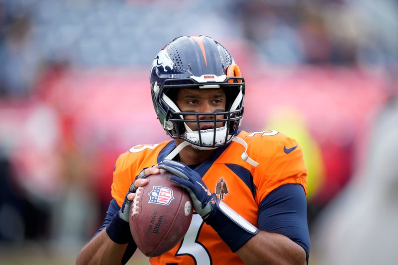 Denver Broncos quarterback Russell Wilson warms up before the start of an NFL football game between the Kansas City Chiefs and the Denver Broncos Sunday, Oct. 29, 2023, in Denver. (AP Photo/David Zalubowski)