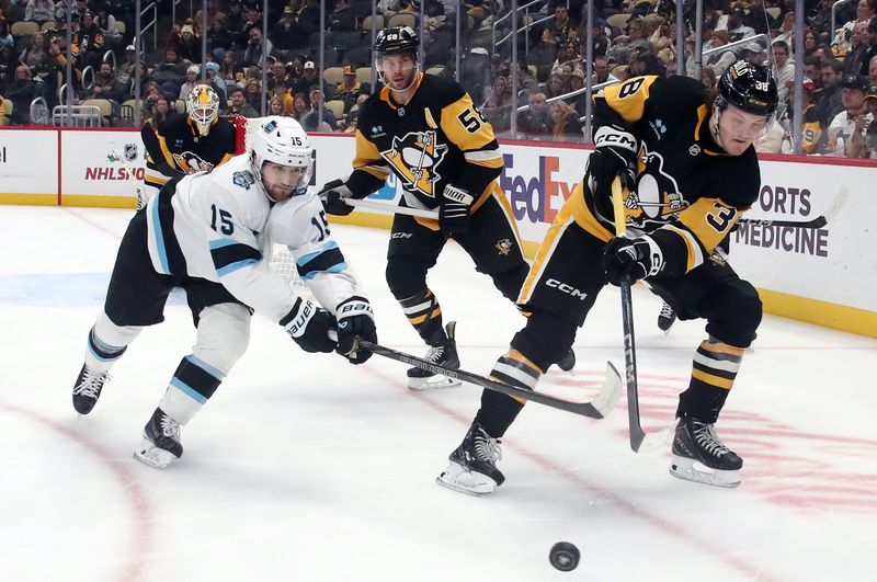 Nov 23, 2024; Pittsburgh, Pennsylvania, USA;  Pittsburgh Penguins defenseman Owen Pickering (38) clears the puck against Utah Hockey Club center Alexander Kerfoot (15) during the second period at PPG Paints Arena. Mandatory Credit: Charles LeClaire-Imagn Images