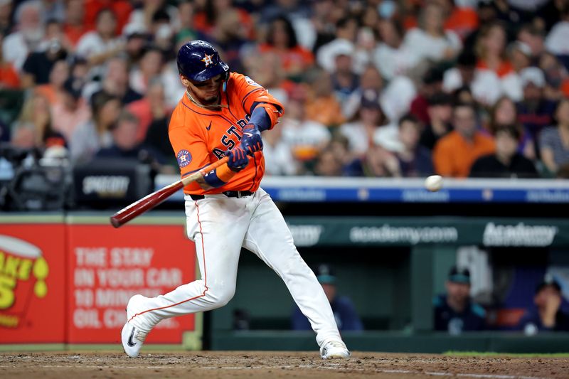 May 23, 2025; Houston, Texas, USA; Houston Astros third baseman Isaac Paredes (15) hits a single against the Seattle Mariners during the fifth inning at Daikin Park. Mandatory Credit: Erik Williams-Imagn Images