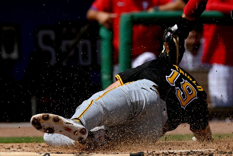 Mar 18, 2024; Clearwater, Florida, USA;Philadelphia Phillies catcher J.T. Realmuto (10) attempts to tag out  Pittsburgh Pirates second baseman Jared Triolo (19) in the second inning of the spring training game at BayCare Ballpark. Mandatory Credit: Jonathan Dyer-USA TODAY Sports