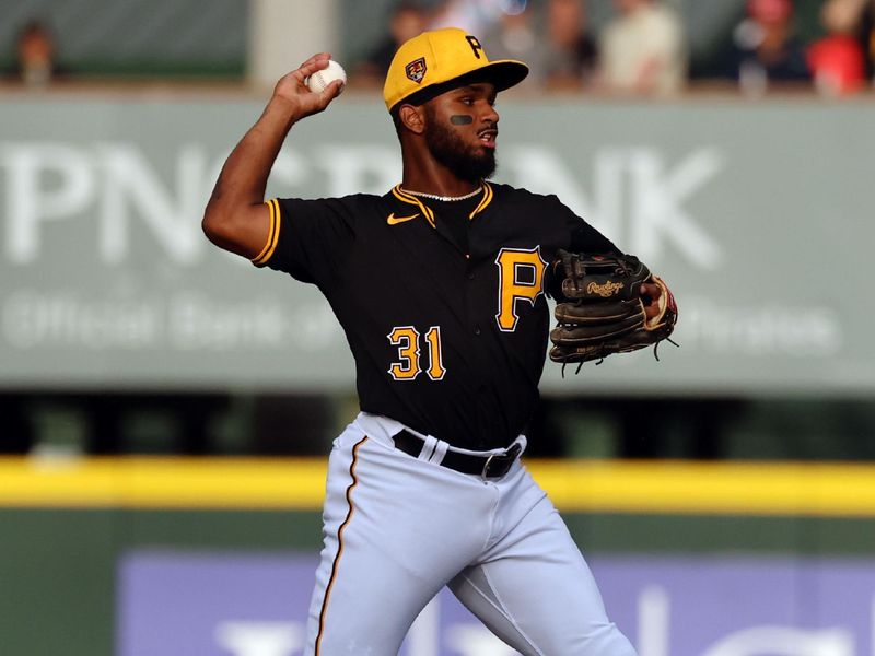 Mar 21, 2024; Bradenton, Florida, USA; Pittsburgh Pirates shortstop Liover Peguero (31) forces an out at second base and throw the ball to first base during the third inning at LECOM Park. Mandatory Credit: Kim Klement Neitzel-USA TODAY Sports