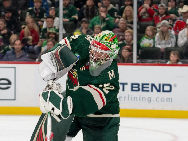 Dec 14, 2023; Saint Paul, Minnesota, USA; Minnesota Wild goaltender Filip Gustavsson (32) plays the puck at Xcel Energy Center. Mandatory Credit: Matt Blewett-USA TODAY Sports