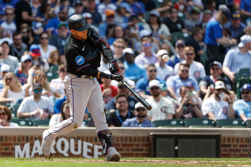 May 5, 2023; Chicago, Illinois, USA; Miami Marlins first baseman Yuli Gurriel (10) hits a sacrifice fly against the Chicago Cubs during the sixth inning at Wrigley Field. Mandatory Credit: Kamil Krzaczynski-USA TODAY Sports