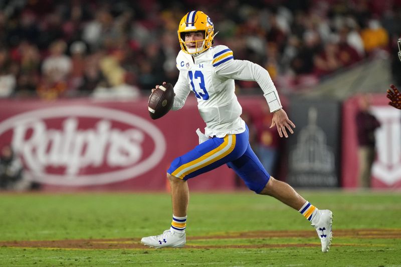 Nov 5, 2022; Los Angeles, California, USA; California Golden Bears quarterback Jack Plummer (13) carries the ball against the Southern California Trojans in the first half at United Airlines Field at Los Angeles Memorial Coliseum. Mandatory Credit: Kirby Lee-USA TODAY Sports