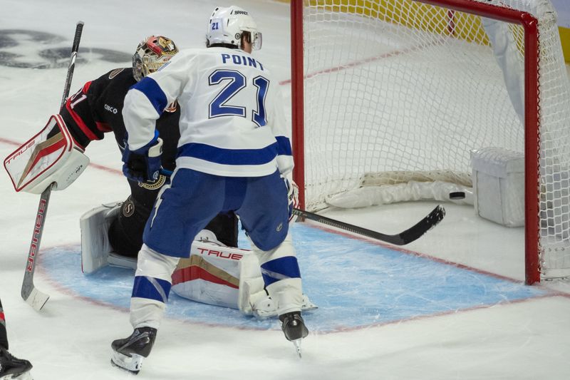 Nov 4, 2023; Ottawa, Ontario, CAN; Tampa Bay Lightning center Brayden Point (21) scores against Ottawa Senators goalie Anton Forsberg (31) in the third period at the Canadian Tire Centre. Mandatory Credit: Marc DesRosiers-USA TODAY Sports