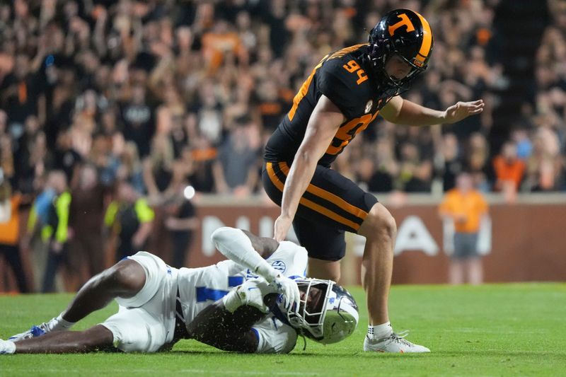 Nov 2, 2024; Knoxville, Tennessee, USA; Kentucky Wildcats wide receiver Barion Brown (7) goes down under Tennessee Volunteers defensive lineman Nathan Robinson (94) during the first half at Neyland Stadium. Mandatory Credit: Caitie McMekin/USA TODAY Network via Imagn Images
